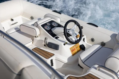 Cockpit of 2019 Princess F50 yacht with steering wheel and control panel.