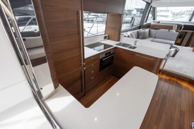 Luxurious interior of 2026 Princess F65 yacht featuring modern kitchen and seating area.