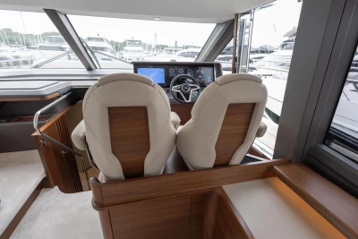Interior of 2026 Princess F65 yacht with modern helm and luxurious seating.