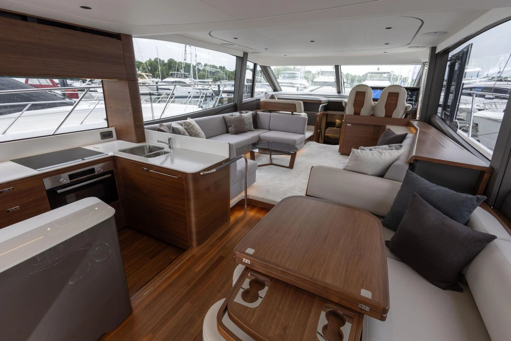 Luxurious interior of 2026 Princess F65 yacht with modern kitchen and elegant seating area.