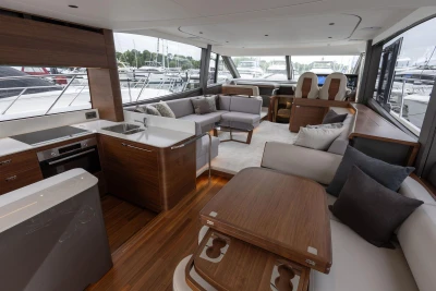 Luxurious interior of 2026 Princess F65 yacht with modern kitchen and elegant seating area.