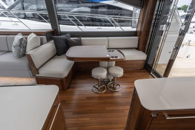 Luxurious interior of 2026 Princess F65 yacht with elegant seating and wooden flooring.