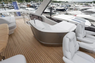 Luxurious 2026 Princess F65 yacht deck with elegant seating and sleek design in a marina setting.