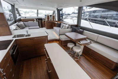 Luxurious interior of 2026 Princess F65 yacht with modern kitchen and seating area.