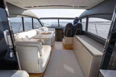 Luxurious interior of 2018 Princess V50 yacht with elegant seating and panoramic windows.