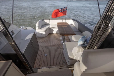 Luxurious 2018 Princess V50 yacht deck with elegant seating and wooden table.