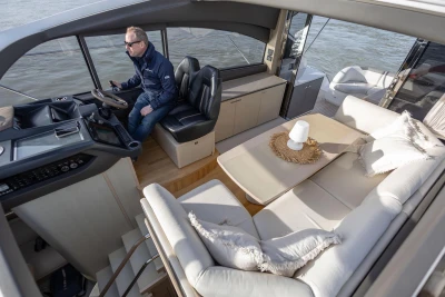 Luxurious interior of 2018 Princess V50 yacht with modern seating and helm station.