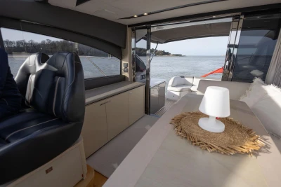 Luxurious interior of 2018 Princess V50 yacht with elegant seating and scenic water view.