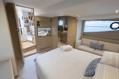 Luxurious 2018 Princess V50 yacht interior with cozy bedroom, TV, and modern decor.