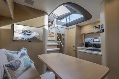 Luxurious interior of 2018 Princess V50 yacht with modern kitchen and seating area.