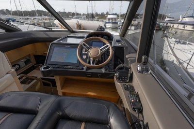 2018 Princess V50 yacht cockpit with navigation system and luxurious steering wheel.
