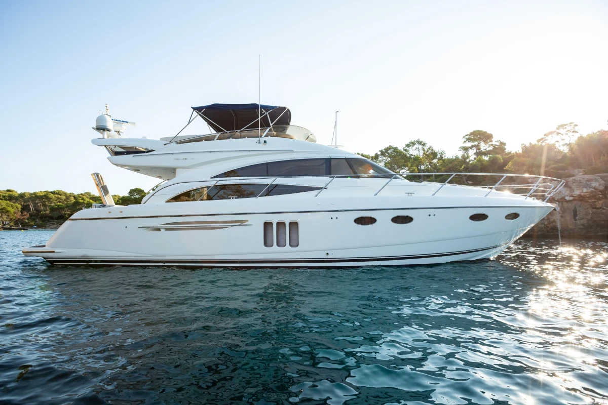 Luxury 2008 Princess 58 yacht on serene water with scenic background.