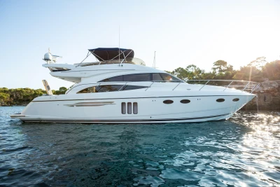 Luxury 2008 Princess 58 yacht on serene water with scenic background.