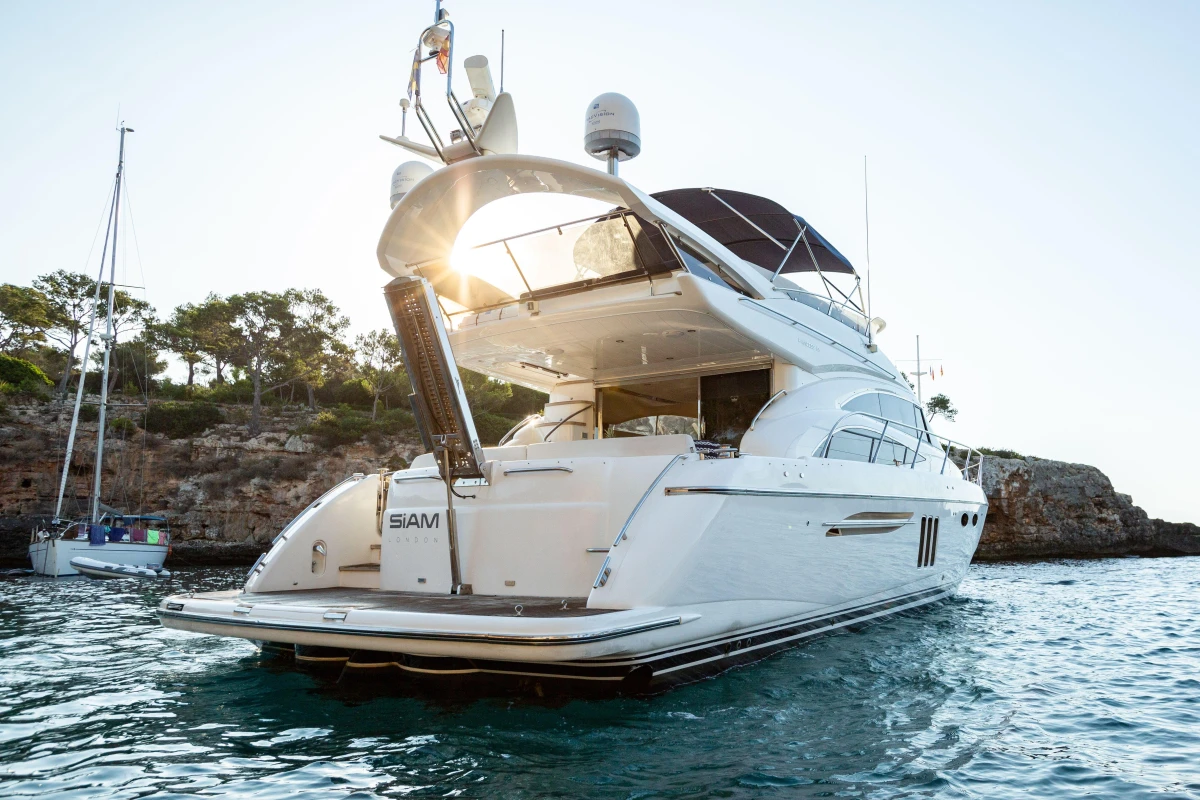 Luxurious 2008 Princess 58 yacht anchored in scenic coastal waters.