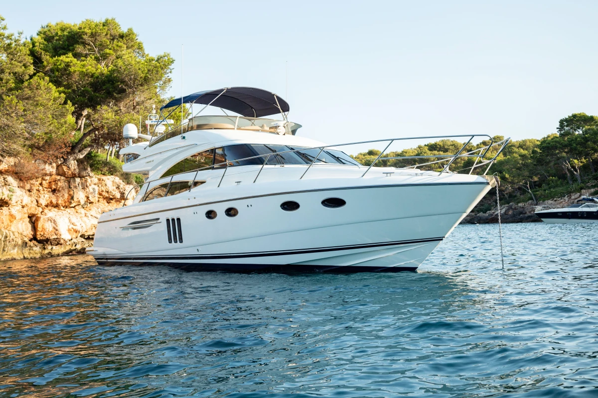 Luxury 2008 Princess 58 yacht anchored in scenic coastal waters.
