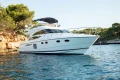 Luxury 2008 Princess 58 yacht anchored in scenic coastal waters.