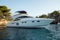 Luxury 2008 Princess 58 yacht cruising in scenic coastal waters.
