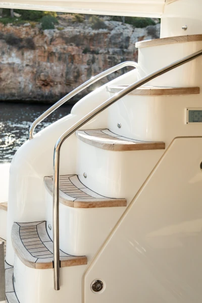 Staircase on 2008 Princess 58 yacht with sleek design and wooden steps.