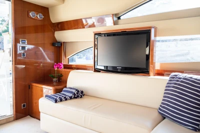 Luxurious interior of 2008 Princess 58 yacht with TV and elegant seating area.