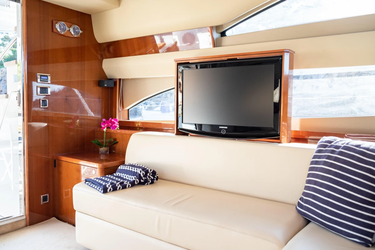 Luxurious interior of 2008 Princess 58 yacht with TV and elegant seating area.