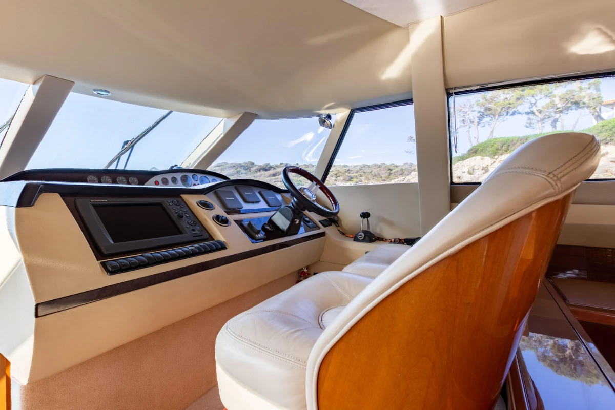 Interior of 2008 Princess 58 yacht cockpit with steering wheel and navigation equipment.