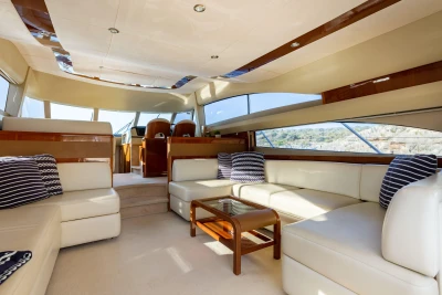 Luxurious interior of a 2008 Princess 58 yacht with elegant seating and panoramic windows.