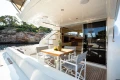 Luxury yacht deck with dining area, Princess 58 model, 2008, scenic coastal view.