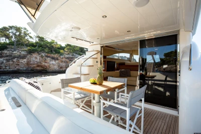 Luxury yacht deck with dining area, Princess 58 model, 2008, scenic coastal view.