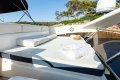Luxurious sun deck on a 2008 Princess 58 yacht with cushions and towels.