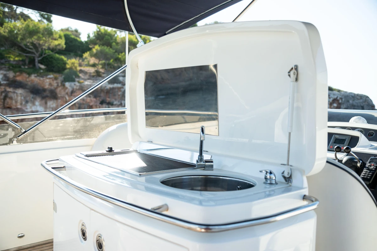 Outdoor kitchen on a 2008 Princess 58 yacht with sink and grill.