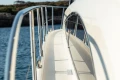 Side view of 2008 Princess 58 yacht deck with railing, overlooking calm water.
