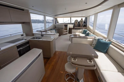 Luxurious interior of 2021 Princess Y72 yacht with modern kitchen and seating area.