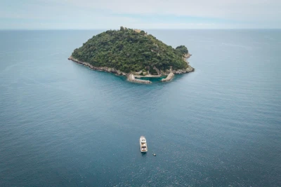 Aerial view of Princess Y72 yacht near a lush island, 2021 model.