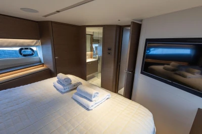 Luxurious bedroom interior of 2021 Princess Y72 yacht with modern amenities and elegant design.