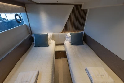 Luxurious twin cabin interior of 2021 Princess Y72 yacht with elegant bedding and decor.