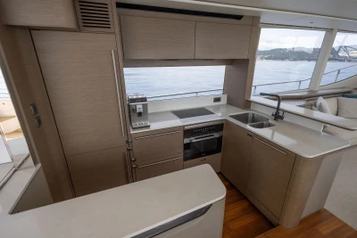 Modern kitchen interior on 2021 Princess Y72 yacht with sleek cabinetry and ocean view.