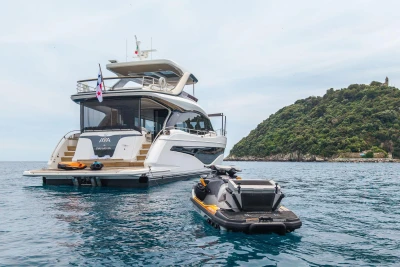 Luxury Princess Y72 yacht with jet ski, anchored near lush island, 2021 model.