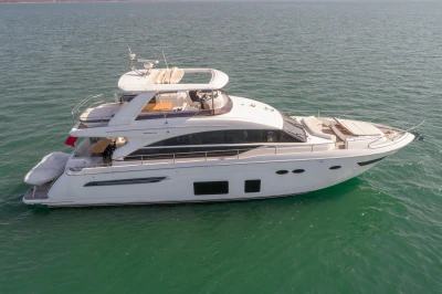 Luxurious white yacht on calm water, featuring a spacious deck and modern design.