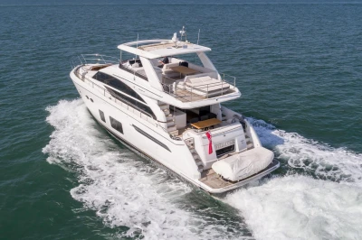 Luxurious white yacht on the sea, featuring multiple decks and sleek lines.