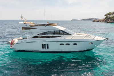 Luxury 2010 Princess 50 yacht cruising on clear turquoise waters.