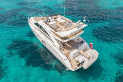 Luxurious 2010 Princess 50 yacht cruising on clear turquoise waters.