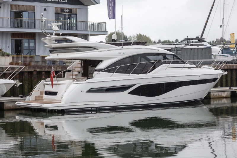 Luxury 2022 Princess F55 yacht docked at marina, showcasing sleek design and elegance.