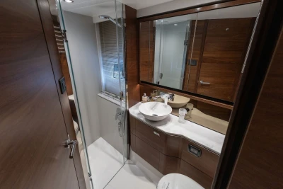 Luxurious bathroom interior of 2022 Princess F55 yacht with modern fixtures and wooden accents.