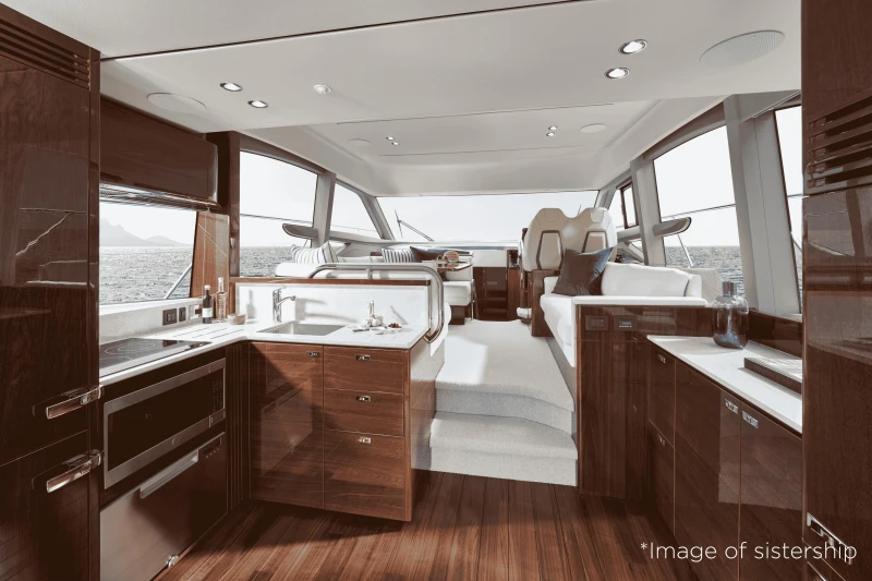 Luxurious interior of 2026 Princess F50 yacht with modern kitchen and seating area.