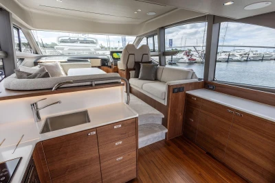 Luxurious interior of 2026 Princess F50 yacht with modern kitchen and seating area.
