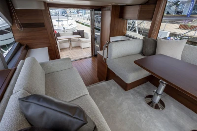 Luxurious interior of 2026 Princess F50 yacht with elegant seating and wooden accents.