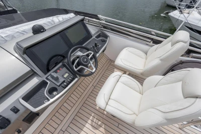 Luxurious 2026 Princess F50 yacht cockpit with modern controls and plush white seating.