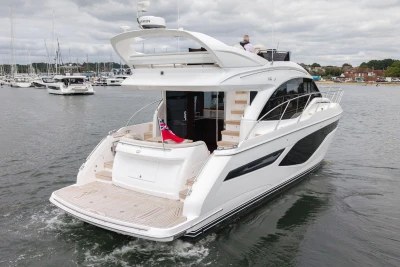 Luxurious 2026 Princess F50 yacht cruising in a marina, showcasing sleek design and elegance.