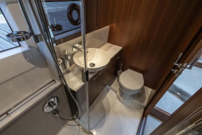 Luxurious bathroom interior of 2026 Princess F50 yacht, featuring modern fixtures and elegant wood paneling.