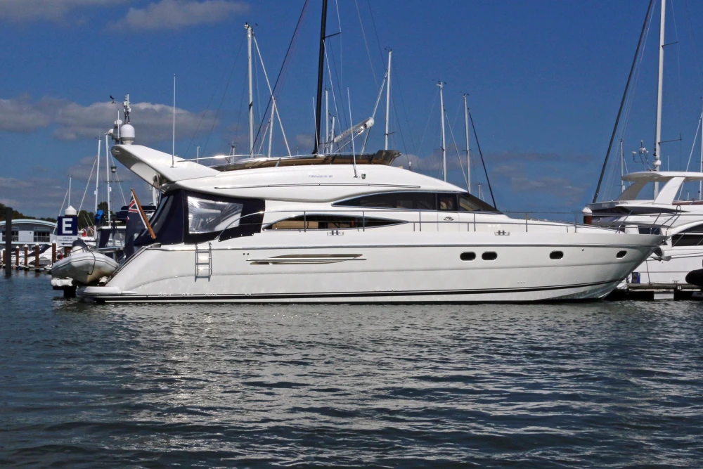 2004 Princess 61 luxury yacht docked in marina.